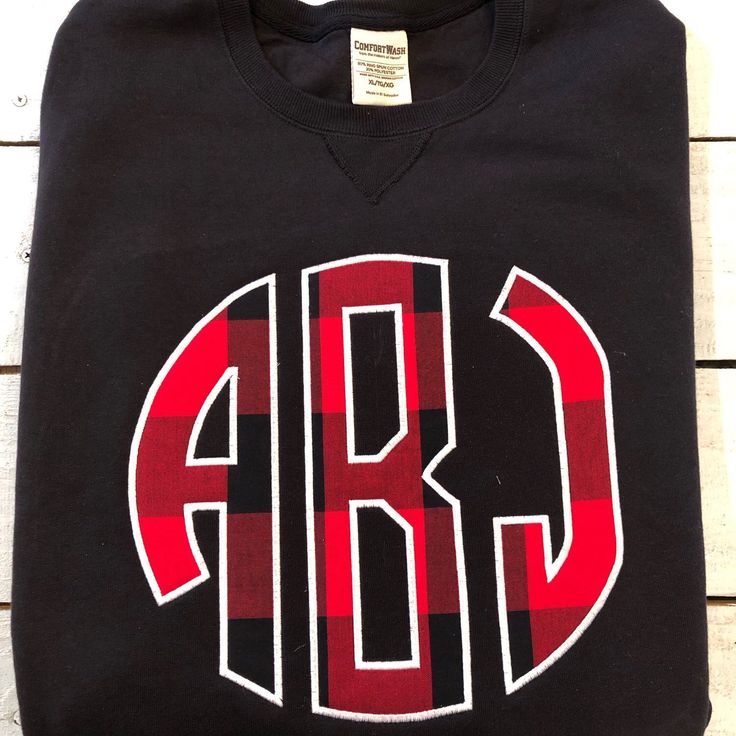 I’m loving this Buffalo plaid monogram!!#buffaloplaid Embroidered School Spirit Tops For Fall, School Spirit Tops With Embroidered Graphics For Fall, Red Tops With Embroidered Logo For Fall, Sporty Fleece T-shirt For Fall, Red Embroidered Tops For Fall, Embroidered Graphics T-shirt For College In Fall, School Spirit Crew Top With Embroidered Graphics, Winter School Spirit Tops With Embroidered Graphics, Monogram Cotton Tops For Fall