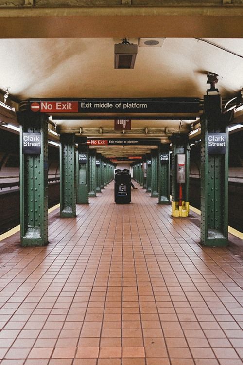 an empty subway station with no people on the platform