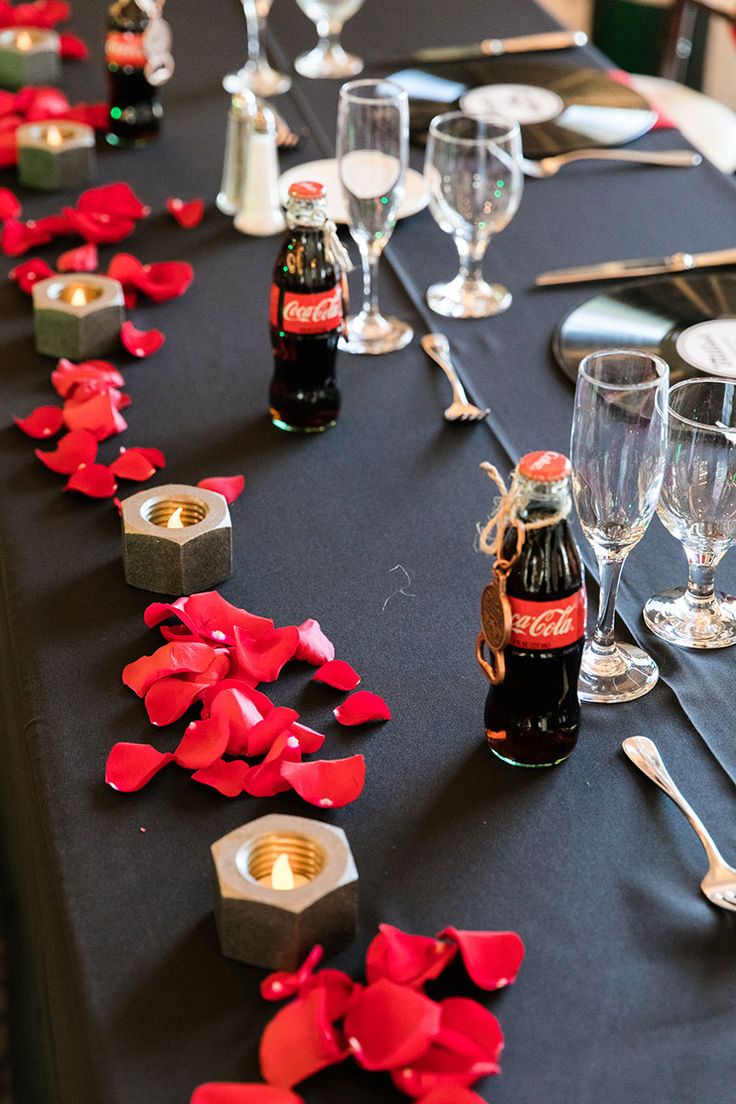 the table is set with empty wine bottles and silverware for guests to sit at