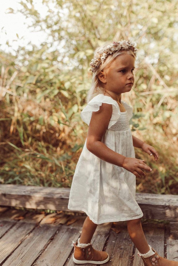 The Haven Swiss Dot Flare Dress offers a timeless style for your little one, featuring a smocked bodice, flutter sleeves, and a flared skirt. Ideal for any event, this piece is sure to become a cherished favorite. Color: ivory. 100% organic cotton AZO dye free smocked bodice Made in India. Jumpsuit Outfit, Dye Free, Boys Pajamas, Swiss Dot, Knitwear Tops, Baby Ideas, Flared Skirt, Skirted Swimwear