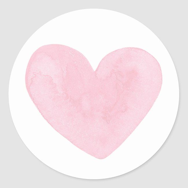 a pink heart on a white background in a round sticker with watercolor effect