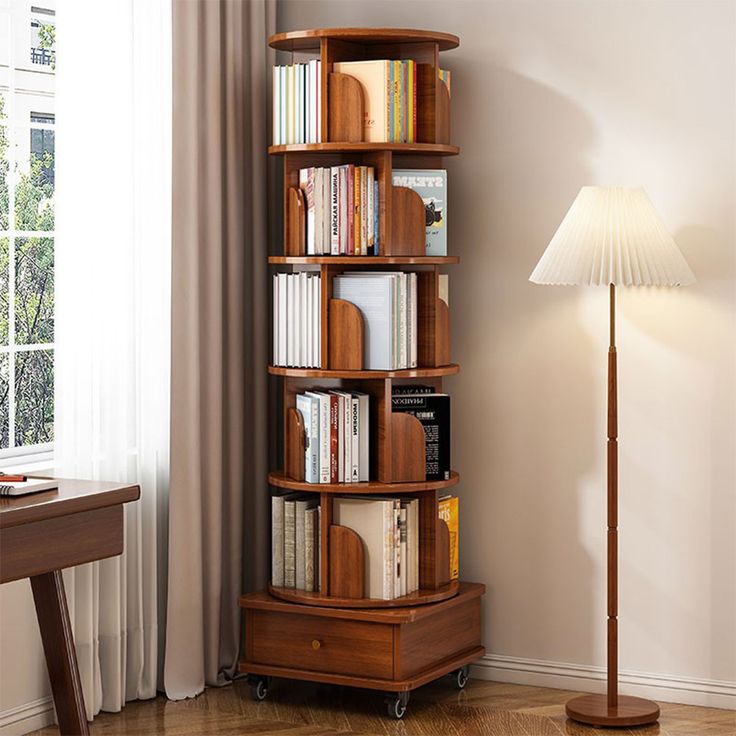 a room with a lamp, bookshelf and a table in front of the window