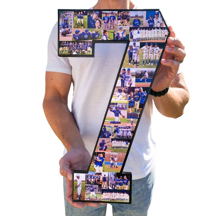 a man holding up the number seven in front of his face with photos on it