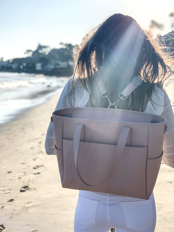 beachy keen with our multi-wear versatile bag. Learn more at https://pondla.com/pages/transform-tote Modern Diaper Bag With Luggage Sleeve For Everyday Use, Modern Diaper Bag With Luggage Sleeve, Versatile Everyday Tote Diaper Bag, Modern Shoulder Diaper Bag For On-the-go, Modern Diaper Bag With Removable Pouch For On-the-go, Everyday Double Handle Diaper Bag With Luggage Sleeve, On-the-go Rectangular Diaper Bag With Top Carry Handle, Daily Use Diaper Bag With Luggage Sleeve, Everyday Diaper Bag With Luggage Sleeve And Double Handle