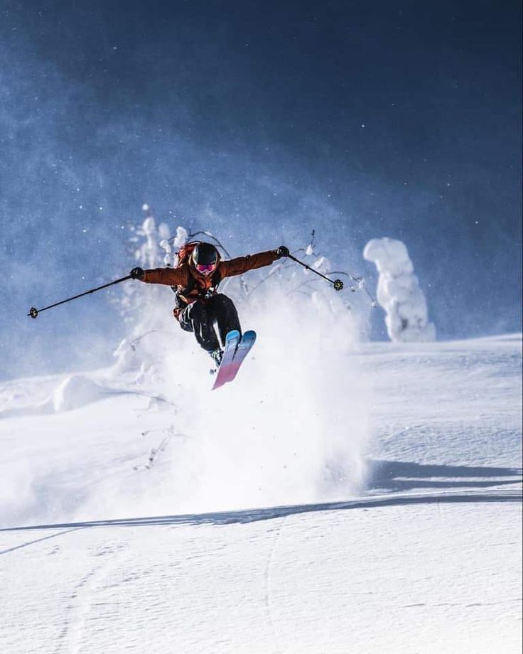 a man flying through the air while riding skis