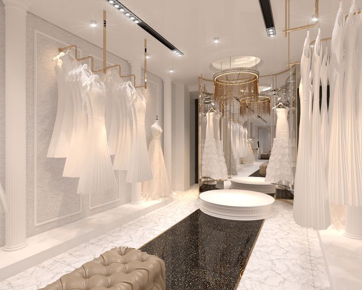 a room filled with lots of white dresses hanging on the walls and clothes hung up