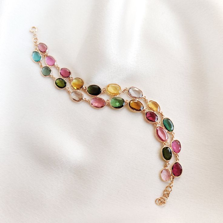 This stunning bracelet is set in 14k Solid Yellow Gold with Natural Multi Tourmaline. It is an unique and dainty gemstone earring bracelet for nearly every occasion and is completely hassle-free jewelry. ITEM DETAILS: * Gem: Multi Tourmaline * Gem Size: Fancy (22pcs) * Gem Shape: mix * Gem Weight: 20.17 carats * Gold Purity: 14KT * Gold Weight: 5.11 gram * Total Weight of the Earrings: 9.14 gram The Gold purity is guaranteed and it comes with authentic 14KT gold hallmark. Since my items are handmade, they are absolutely nickel and lead free. CUSTOMIZATION: * Same Bracelets are available in 14KT as well 18KT gold. Kindly choose your preferred gold purity from the drop-down option. * The Bracelets can be made in 14KT/18KT Yellow, White & Rose Gold. Kindly choose the gold color from the drop- Multi Charm Bracelet, Elegant Adjustable Tourmaline Jewelry, Gold Tourmaline Gemstone Bracelets, Gold Bracelets With Natural Stones And Tourmaline, Gold Tourmaline Bracelet Jewelry, Gold Tourmaline Bracelets With Natural Stones, Gold Tourmaline Bracelet, Elegant Gold Tourmaline Bracelets, Elegant Multicolor Tourmaline Jewelry