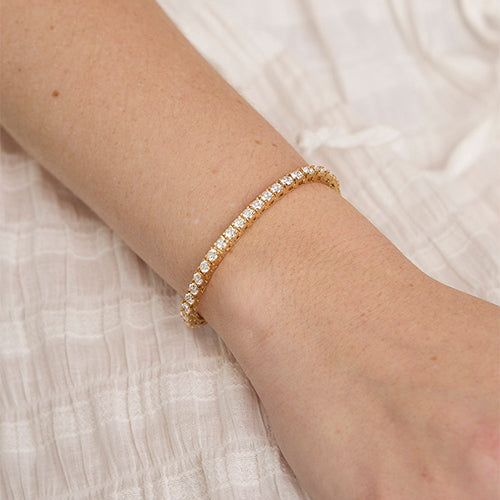 Named after women’s tennis champion Chris Evert, who lost a similar style on the 1987 US Open court, this flexible, close-set diamond bracelet comes adorned with a securely designed clasp that fluidly moves with every gesture (so it’ll stay with you forever). A perennial classic in every era, the single strand looks radiant alone for 5-carats of sparkle and layers with other styles for a more subdued shimmer. Custom sizes are available upon request. Presented in our signature Noémie box. Include Chris Evert, Tennis Champion, Diamond Tennis Bracelet, Us Open, Tennis Bracelet Diamond, 3 Carat, Quality Diamonds, Tennis Bracelet, High Quality Jewelry