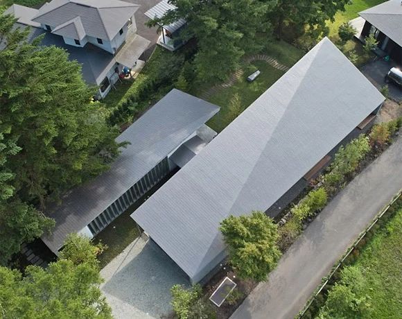 an aerial view of some houses in the woods