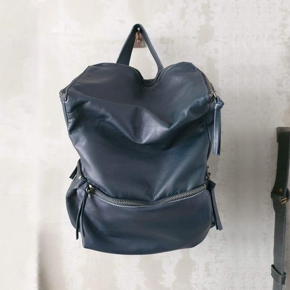 This stunning backpack is made of genuine soft nappa leather in a soft and buttery Dark Blue color.With enough room for all your daily essentials, It is perfect for everyday use, as well as for laptops of all sizes, IPAD, A4 files, books and travel. it as a unique structured with a zipper closure at the top, and three outside zipper pockets for mobile, keys, etc.It is fully lined with black strong cotton fabric which I divide to two large interior, zip pocket, and a leather cell phone pocket, sh Leather Backpack Women, Leather Bag Handmade, Handmade Leather Backpack, Laptop Backpack Women, Leather Hip Bag, Leather Laptop Backpack, Brown Leather Backpack, Backpack Laptop, Leather Backpack Purse