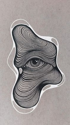 an eye sticker on the side of a gray paper with black and white lines