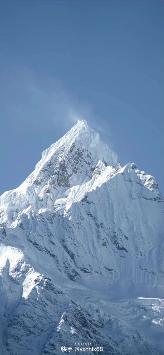 a large snow covered mountain in the middle of winter