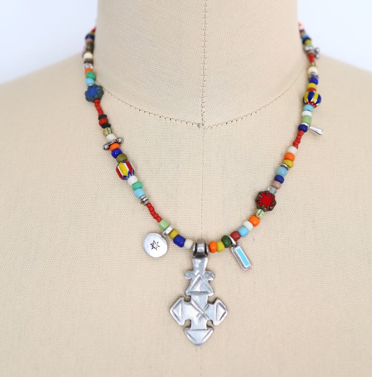 Colorful beaded necklace. Embrace a fusion of tradition and style with this handmade Coptic Silver cross necklace adorned with a medley of glass beads, from Czech to African glass, exuding a tribal and bohemian allure. Suitable for both men and women, this unique choker design speaks volumes of creativity and spirituality.  Includes lobster clasp with 5 link chain to adjust size (or convo me for your desired length). Elevate your look with this colorful design by Mystic Pieces. Ideal as a gift for a loved one or as a vibrant addition to your jewelry collection. "Coptic Christianity developed in Egypt under Saint Mark, writer of the Gospel of Mark. The Copts became separated from mainstream Christianity at the Council of Chalcedon in 451 CE over theological differences." - learnreligions.co Spiritual Multicolor Pendant Beads, Multicolor Amulet Beads For Gifts, Spiritual Multicolor Pendant Beaded Necklaces, Multicolor Beaded Amulet Pendant Necklace, Spiritual Multicolor Pendant Beaded Necklace, Spiritual Multicolor Beaded Pendant Necklace, Adjustable Multicolor Amulet Beaded Necklaces, Spiritual Style Multicolor Beaded Necklaces With Silver Beads, Multicolor Large Beads Amulet Necklace