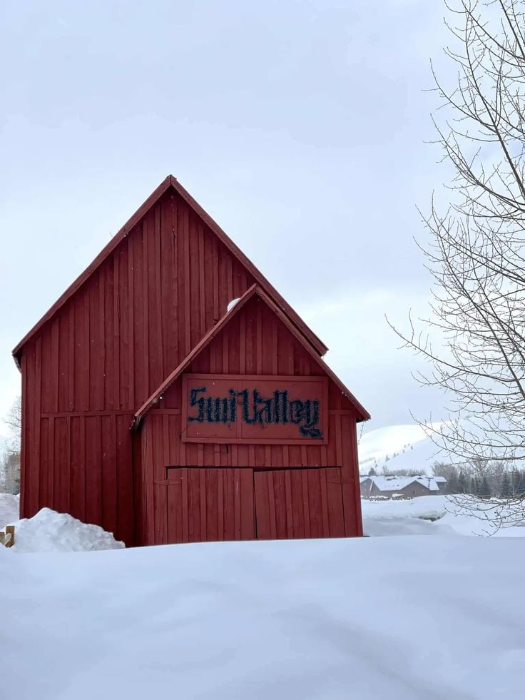 a red building with a sign on it in the snow