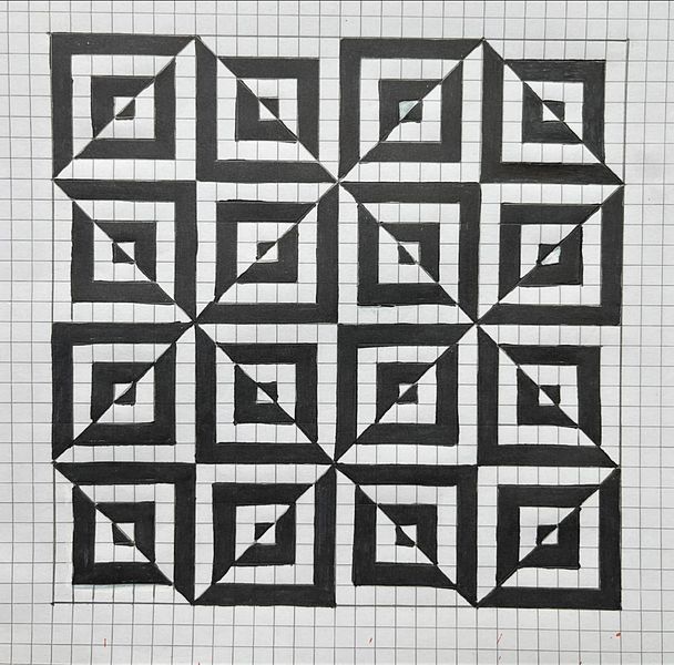 a black and white quilt with squares in the middle on a sheet of paper next to a ruler