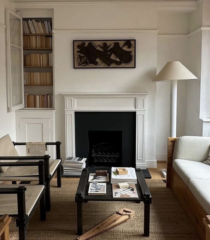 a living room filled with furniture and a fire place under a painting on the wall