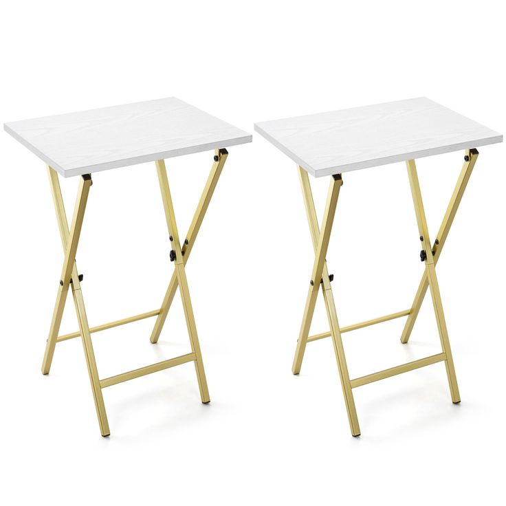 two white tables sitting side by side on top of each other, one with a gold frame