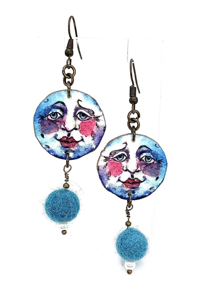 These amusing and colorful earrings are the perfect addition to any accessory wardrobe. Once in a blue moon is a favorite theme of mine that I have used in many of my designs. The earrings are embellished with handmade felted wool baubles and a tiny pearl. The earrings are 2 inches in length and are attached to antique brass ear wires. Once In A Blue Moon, Green Valley, Colorful Earrings, Moon Earrings, Felted Wool, Clay Creations, Blue Moon, Ear Wires, Wool Felt