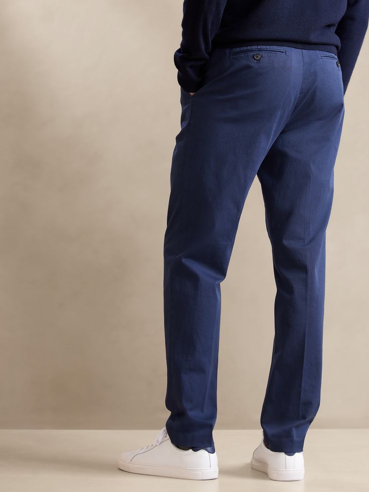 Inspired by a pair from the Banana Republic archives, these sumptuous chino pants are made from soft cotton with a special enzyme wash for plush hand feel, and a pleated front with tapered leg for a look that's always polished.  TAPERED FIT: Mid rise Cotton Dress Pants With Straight Tapered Leg, Tailored Cotton Dress Pants With Tapered Leg, Relaxed Fit Tapered Leg Chino Dress Pants, Tapered Chinos With Pockets For Work, Tailored Cotton Chinos In Casual Style, Tailored Cotton Chinos Casual Style, Tailored Tapered Leg Cotton Bottoms, Classic Tapered Chinos With Pockets, Casual Tailored Chinos Tapered Leg