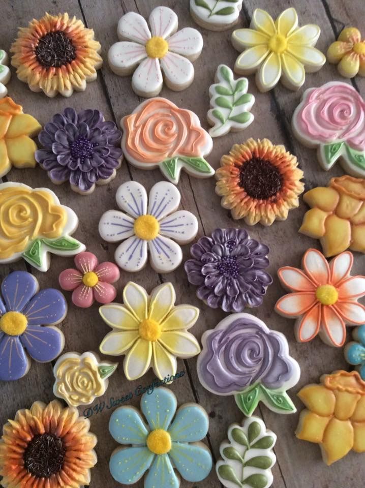 colorful cookies decorated with flowers and leaves on a table