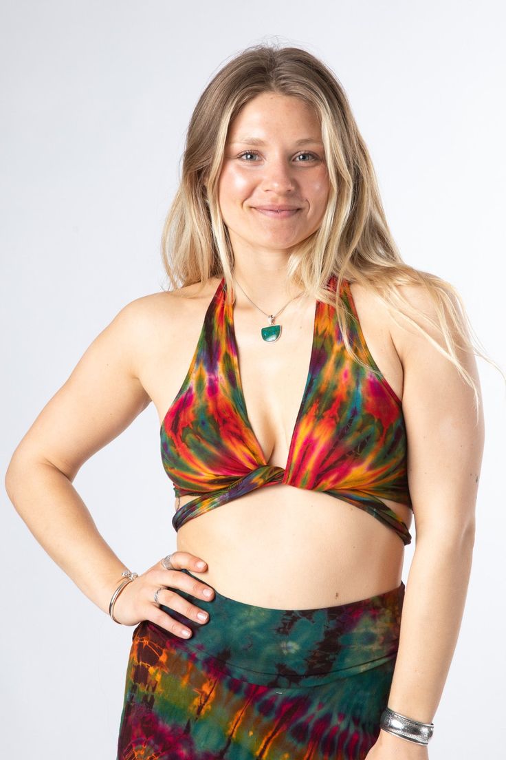 We took one of our favorite tops even further into the psychedelic colorful explosion of hippie fashion. The perfect top for athletic or casual endeavors, it can be worn as an undergarment or a boho bralette, as a supportive garment when exercising, as a psychedelic swimsuit top, or all on its own as a cute hippe statement top. Tied in the front, or tied around back, it doesn't matter as all is groovy as long as it's Tie Dye ✌️ Which one will you get? Festival Beachwear Halter Top With Built-in Bra, Summer Festival V-neck Halter Top, Multicolor Bra-friendly Tops For Summer, Summer Multicolor Bra-friendly Tops, Bohemian Halter Top With Built-in Bra For Summer, Bra-friendly Crop Halter Top For Yoga, Bohemian Halter Top With Built-in Bra, Summer Multicolor Tops With Built-in Bra, Bohemian Beach Tops With Built-in Bra