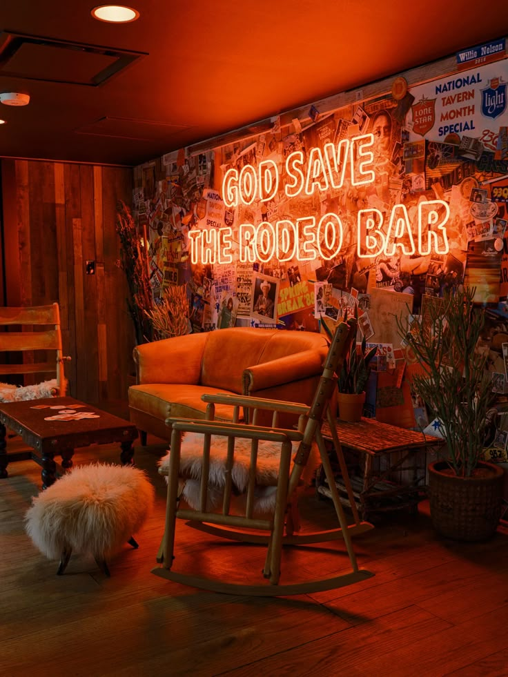 a neon sign that reads god save the rodeo bar in front of a rocking chair