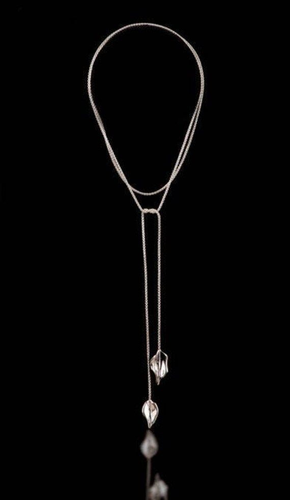 This Sterling Silver Two Leaf Lariat is flexible, easy to wear and comfortable and can be worn a couple of different ways because it has such a long chain. It can be made in 18kt Gold as well. It looks really relaxed and chic. The leaves are made by casting and soldered to the chain. The Chain is 1.2 mm in thickness so it is a dainty and delicate look. Very feminine. Double Chain Lariat Necklace, Silver Chain Lariat Necklace, Elegant Lariat Necklace With Silver Chain And Gold Color, Elegant Multi-strand Long Necklace With Adjustable Chain, Elegant Adjustable Chain Backdrop Necklace, Elegant Adjustable Backdrop Necklace, Elegant Lariat Necklace With Double Chain As Gift, Elegant Lariat Necklace With Silver Chain, Adjustable Silver Chain Lariat Necklace