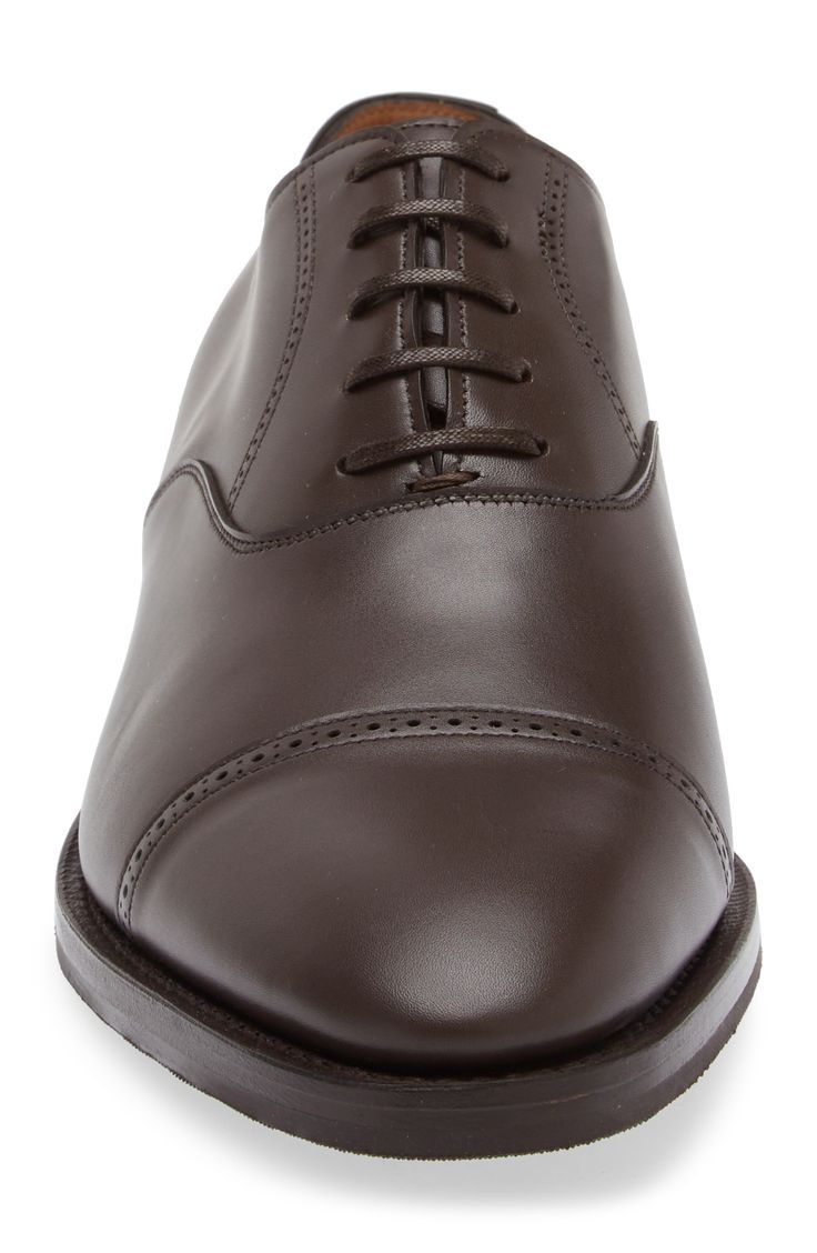 Epitomizing minimalist styling and expert craftsmanship, this sleek leather oxford crafted in Britain is cut with a softly tapered cap toe with brogued details. Lace-up style Leather upper and lining/synthetic sole Made in the UK Designer Shoes Goodyear Welted Cap Toe Oxford For Derby, Cap Toe Oxford Shoes With Goodyear Welted, Timeless Fitted Goodyear Welted Oxfords, Leather Oxford Shoes With Goodyear Welt For Derby, Classic Leather Shoes For Derby, Fitted Cap Toe Oxfords With Leather Lining, Classic Fitted Leather Shoes For Derby, Classic Fitted Almond Toe Oxfords, Classic Cap Toe Oxford With Goodyear Welt