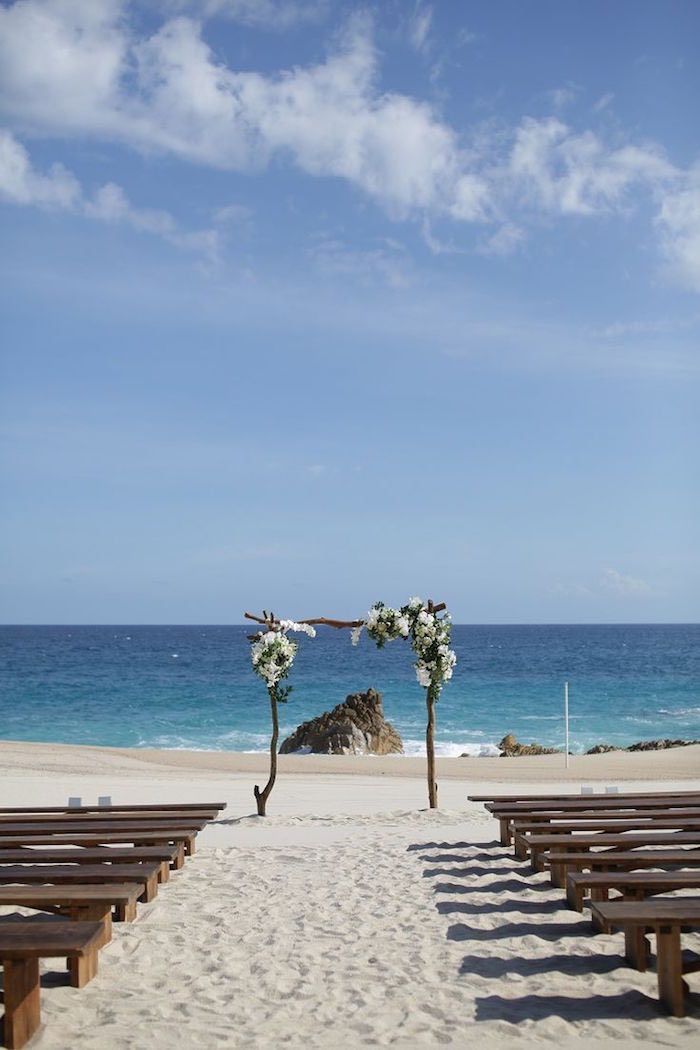 an outdoor ceremony set up on the beach