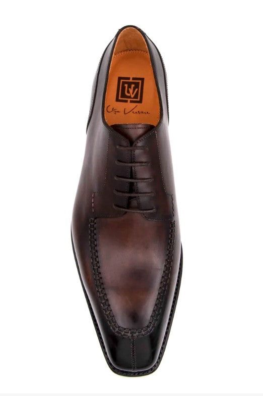 Style: 20141-2002-Brown Simple, Elegant, Stunning! Completely Handmade, this Hand Burnished Calfskin lace-up oxford from the Ugo Vasare collection features Goodyear Welted construction, soft Calfskin lining, cushioned insole, Split-Toe, a stitched welt and a full Leather sole! Matching Belt Available. Don't see your size? This style may be special ordered. Brown Italian Oxfords For Work, Luxury Brown Oxfords For Business Casual, Brown Luxury Oxfords For Derby, Luxury Brown Oxfords For Derby, Luxury Brown Derby Shoes For Office, Luxury Brown Derby For Business Casual, Designer Brown Oxfords For Workwear, Luxury Brown Derby Shoes For Semi-formal, Luxury Brown Lace-up Dress Shoes