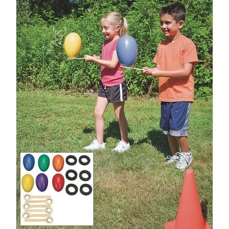 two young children playing with balloons in the grass near cones and markers for each balloon