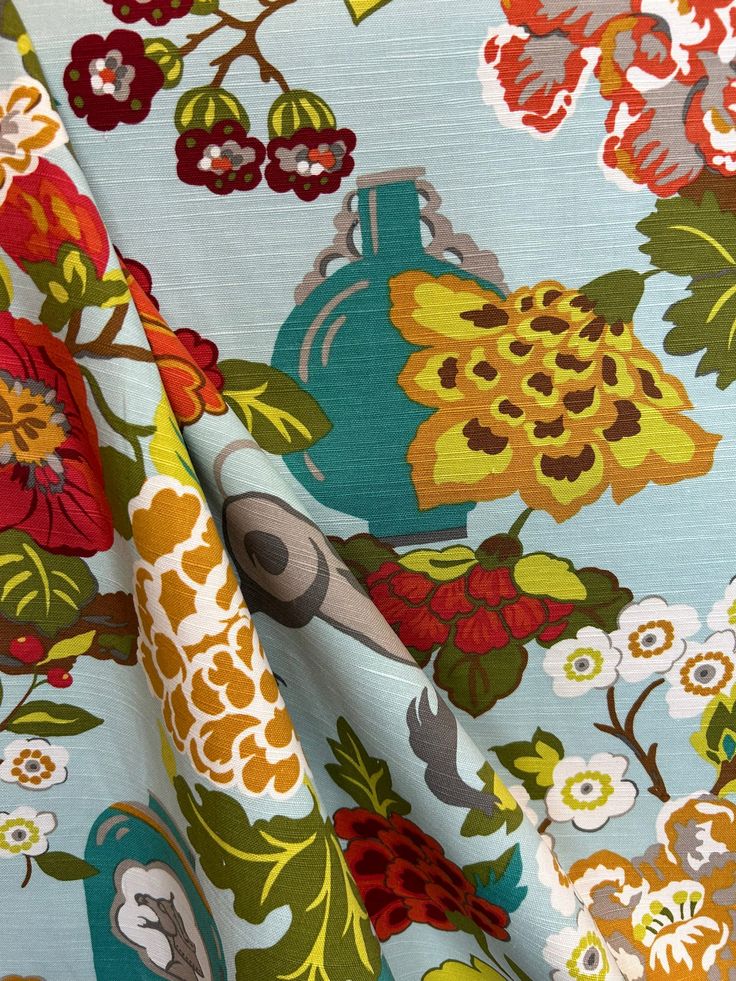 the fabric is very colorful and has flowers on it