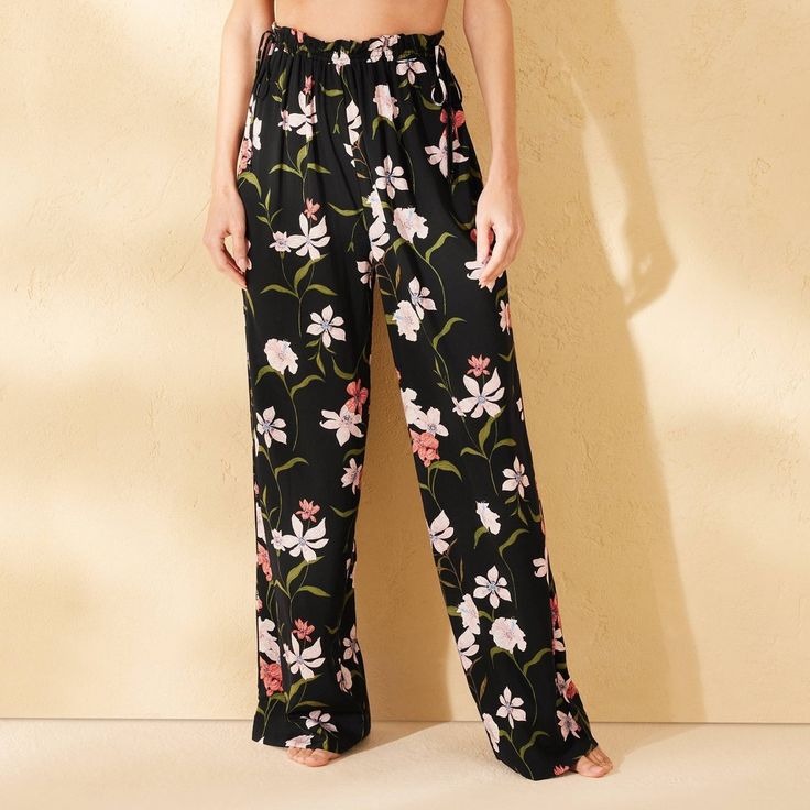 Whether you're strolling along the shoreline or lounging by the poolside, these Ruffle-Waist Cover-Up Pants from Shade & Shore™ are a go-to pick for any occasion. These sheer cover-up pants are made from breathable lawn fabric for comfortable wear. Designed with a ruffled elastic waist for a snug fit, these floral print pants are perfect for layering over a bikini bottom or one-piece swimsuit. Shade & Shore™: Made for the sun & fit for fun. Summer Long Pants For Poolside, Floral Print Pants For Beach Day Out, Chic Bottoms For Day Out During Resort Season, Beachwear Pants With Elastic Waistband For Poolside, Floral Print Beach Loungewear Bottoms, Beach High-waisted Floral Print Pants, High-waisted Floral Print Beach Pants, High-waisted Floral Beach Pants, Floral Print Pants For Vacation And Beach Season