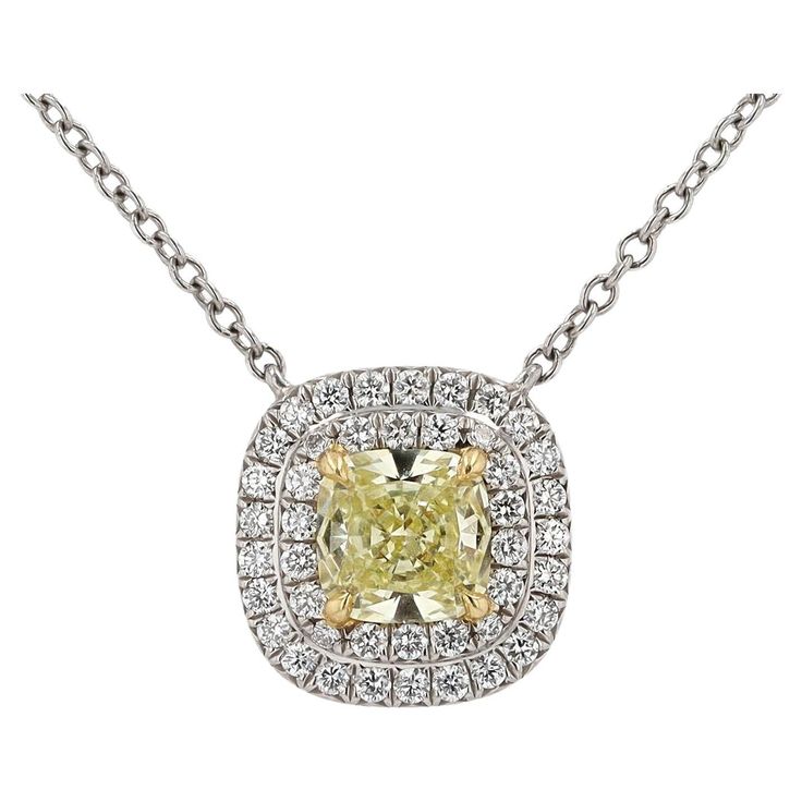 A signed Tiffany & Co. natural Yellow Diamond pendant necklace, from the legacy jewelers' Soleste Collection. The center diamond, a Fancy Yellow color shines with modified facets providing extra sparkle. The near 3/4 carat center diamond is set in 18k yellow gold prongs and surrounded with a double halo of 43 near colorless accent diamonds, expertly crafted in enduring platinum with authentic Tiffany hallmarks.   Condition: Excellent Era: Contemporary Year: 2016 Metal: 18k Yellow Gold & Platinum Platinum Gemstone Necklace In Fine Jewelry Style, Gold Platinum Necklace With Vvs Clarity, Luxury Yellow Necklace With Diamond Accents, Gold Diamond Cut Platinum Necklace, Platinum Pendant Necklace With Gemstone, Platinum Diamond Necklace With Gemstone, Platinum Gold Diamond Cut Necklace, Gold Platinum Necklace With Diamond Cut, Luxury Yellow Necklaces With Diamond Accents