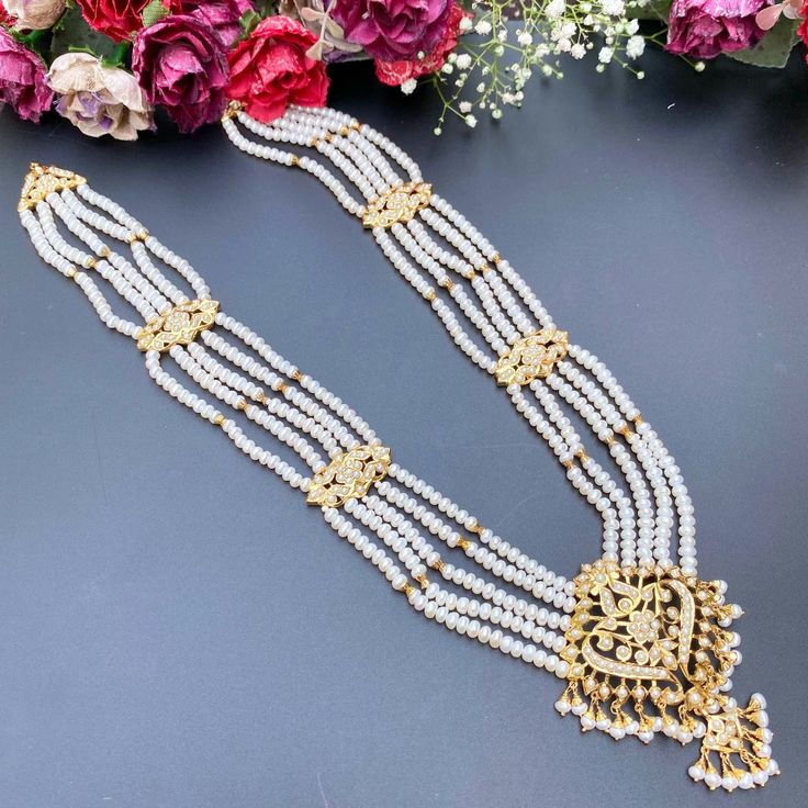 Featuring a long pearl necklace in gold plated silver embellished with freshwater pearls. This exquisite piece of jewelry is perfect for any occasion, from office parties to elegant soirees. Its lustrous pearls and gleaming gold-plated silver will add an exquisite touch of luxury to your look. Raani Haar, 22k Gold Jewelry Necklaces, Long Pearl Necklace, 22k Gold Jewelry, Long Pearl Necklaces, Pearl Necklace Set, Gold Jewelry Necklace, Emerald Necklace, Gold Bangle Bracelet