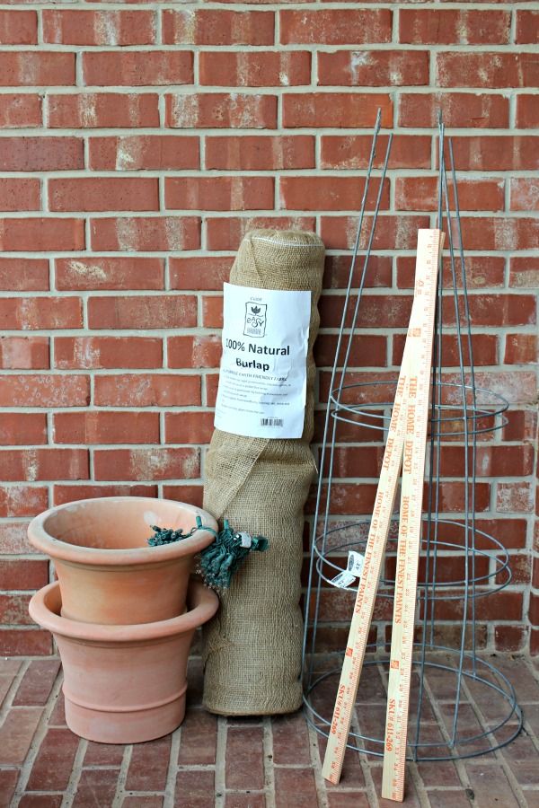 two clay pots and one planter are sitting next to each other on the ground