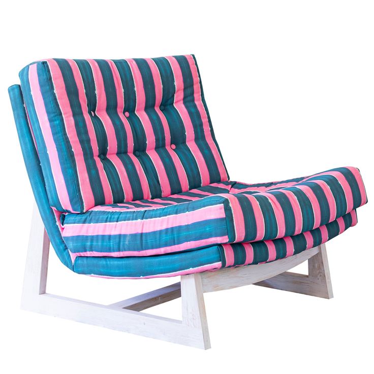 a blue and pink striped chair sitting on top of a white table