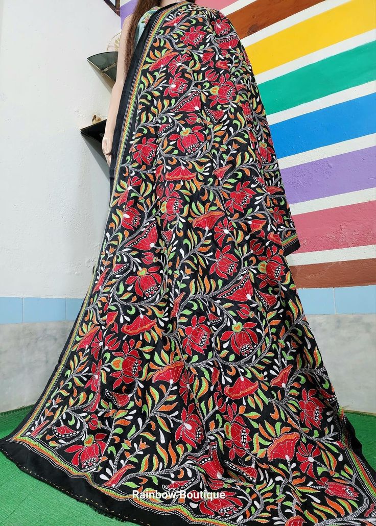 This Nakshi Kantha Stitch Dupatta is done by a Skilled  Kantha Artist from West Bengal.  Kantha is a running-stitch style from West Bengal, where multi-color and multi-thread with elaborate designs are vividly embroidered onto the textile to give it a textured aesthetic. This Floral Dupatta is hand embroidered & and comprises the vibrant colors & and design motif of florals and birds. Dupatta Length : 2.5 meters Dupatta Width : 44 Inches Design : Nakshi Kantha Hand Embroidery Fabric : Bangalore -- Silk Mark Certified. Color :  Blue, Brown and Magenta Washing : Dry Clean Get this exclusive Hand Embroidered Kantha Saree online at Rainbow Boutique - The best online store for pure silk saree, tussar silk saree. Multicolor Semi-stitched Embroidered Fabric For Puja, Unstitched Cotton Choli With Resham Embroidery, Multicolor Cotton Blouse Piece With Motifs, Unstitched Traditional Cotton Choli, Unstitched Cotton Traditional Choli, Multicolor Choli With Resham Embroidery For Puja, Unstitched Cotton Choli Traditional Style, Black Embroidered Chanderi Dupatta, Traditional Black Embroidered Saree