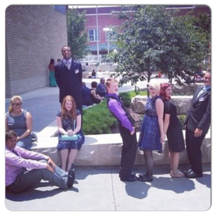 a group of people sitting and standing around each other