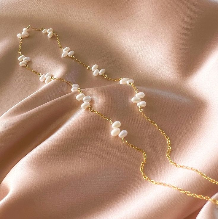 This delicate freshwater bead pearl necklace stands on it's own as a classic wardrobe staple and can be layered with any necklace.Handmade and attached to a delicate 14k gold-plated chain.Adjustable length "16-18". Gold Single Strand Feminine Necklace, Feminine Gold Single Strand Necklace, Adjustable Pearl Necklace With Delicate Chain, Pearl Lariat Necklace With Delicate Chain, Adjustable Lariat Pearl Necklace, Delicate Gold Single Strand Pearl Necklace, Adjustable Gold Plated Pearl Necklace With Pearl Drop, Adjustable Delicate Chain Pearl Necklace For Everyday, Pearl White Lariat Necklace With Pearl Chain As Gift