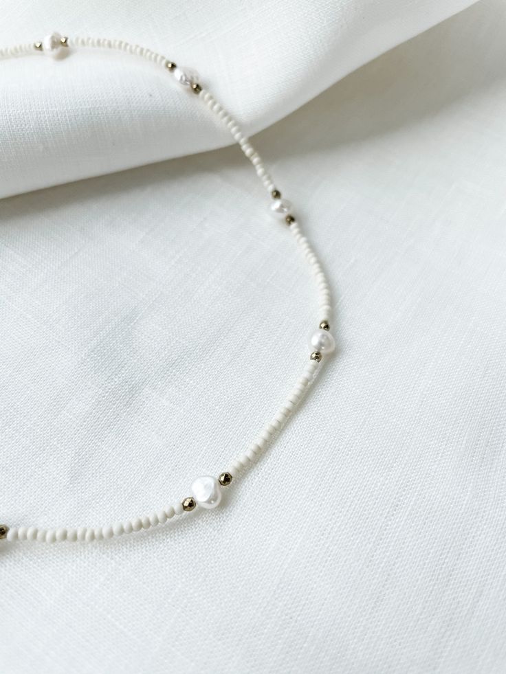 "Ivory seed beads with natural pearls and 3mm faceted hematite spacers. Necklace had lobster clasp closure with 2\" adjustable chain. Each piece is designed and handmade in Brooklyn. After visiting the Notre Maison orphanage in 2015, I fell in love with the children and knew I wanted to help sponsor them. That's what started this shop. Every purchase helps us sponsor 5 children at the orphanage that we follow up with and visit over the summers. Join our Ubuntu family so that together we can be t White Pearl Jewelry With Oval Beads, White Pearl Jewelry With Faceted Beads, Adjustable Pearl Beaded Necklace With Round Beads, Adjustable Pearl Beaded Necklace With Spacer Beads, Adjustable Faceted Bead Pearl Necklace, White Pearl Beaded Bracelets With Polished Beads, Pearl White Necklaces With Faceted Beads, White Tiny Beaded Necklaces For Jewelry Making, White Polished Pearl Beaded Bracelets