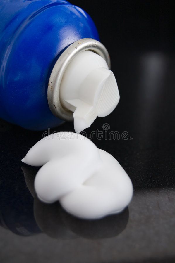 an open blue bottle with white caps on a black surface royalty images and stock photos