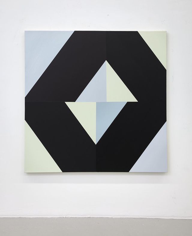 an abstract painting with black, white and blue shapes on the wall next to it