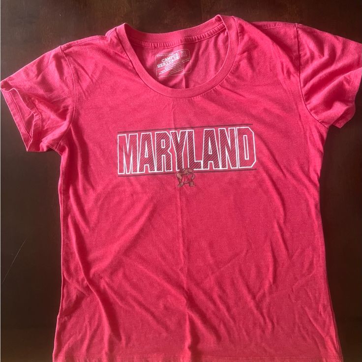 Maryland Tee Shirt. Size Xl Never Worn. Spring Fan Apparel Tops, Red Graphic Tee For Fans, Red Screen Print Shirt For Spring, Pink Cotton Fan Apparel Tops, Casual Pink Tops For Fan Merchandise, Red Relaxed Fit Fan Apparel T-shirt, Casual Red Shirt With Screen Print, Red Relaxed Fit T-shirt Fan Apparel, Red Relaxed Fit T-shirt For Fans