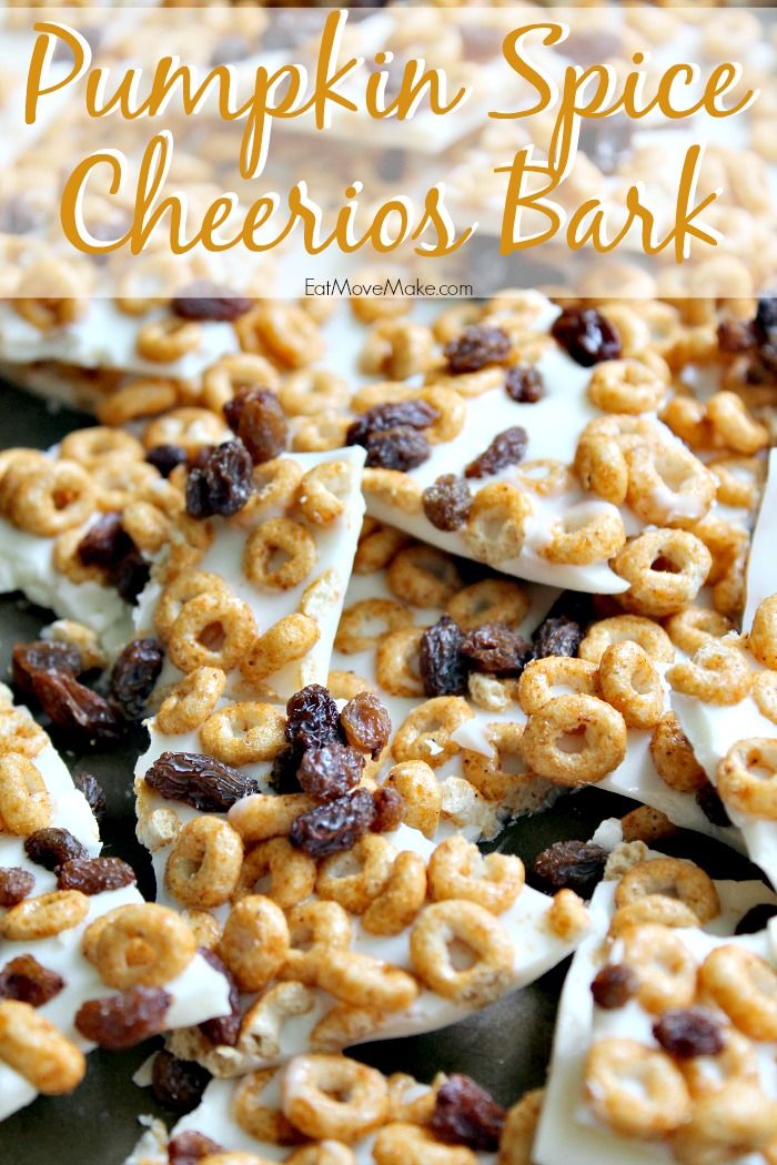 pumpkin spice cheerios bark with white frosting and raisins in the middle