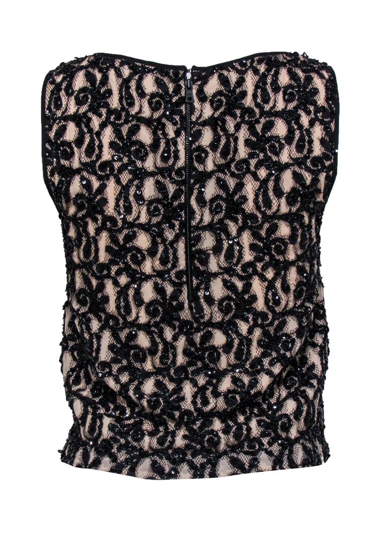 You are the life of the party when you walk into the room in this embellished top from Alice & Olivia! Complete with sequins, beads, and lace contrasting a nude sheer overlay with sharp black trim and a bold back exposed zipper. Style with a leather miniskirt, tall boots and a bright red lip for a Saturday night to remember. Pair with patent pumps, sleek black denim, and a leather jacket for a bit of edge! Size S Shell: 85% Cotton, 15% Nylon Combo: 100% Viscose Lining: 97% Polyester, 3% Elastane Glamorous Sleeveless Tops With Contrast Sequin, Glamorous Sleeveless Contrast Sequin Top, Glamorous Sleeveless Sequin Tops, Black Contrast Sequin Fabric, Embellished Sleeveless Top For Evening, Sleeveless Embellished Top For Evening, Glamorous Sleeveless Holiday Tops, Glamorous Embellished Black Tank Top, Glamorous Black Embellished Tank Top