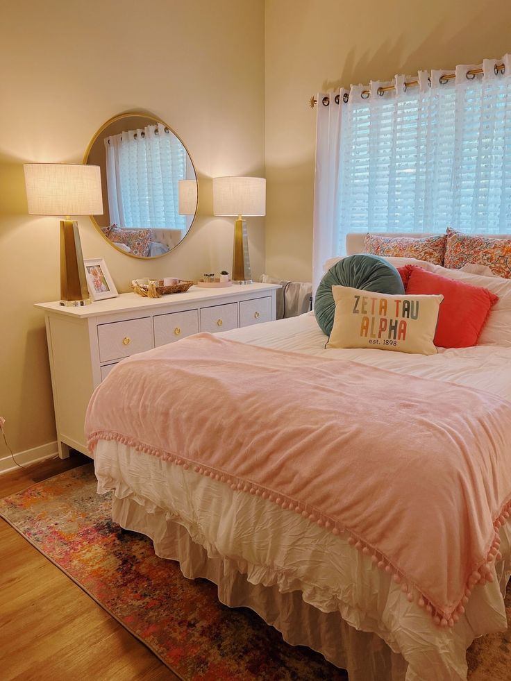 a bedroom with a bed, dresser and mirror in the corner that has been decorated