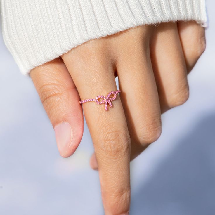 Give the present of a sparkly surprise with this pink pavé bow ring. Available in gold and silver finish, this sterling silver ring is perfect gift idea for teenage girls, girlfriend, daughter, friends, sisters, mother, family or wife. Get the cute ring for the special woman in your life on birthday, anniversary, etc. Pink Bow Jewelry For Anniversary, Feminine Pink Rings For Gift, Wedding Jewelry With Pink Bow, Gift Jewelry With Pink Bow, Valentine's Day Gift Jewelry With Pink Bow, Cute Ring, Mother Family, Fun Bracelet, Bow Ring