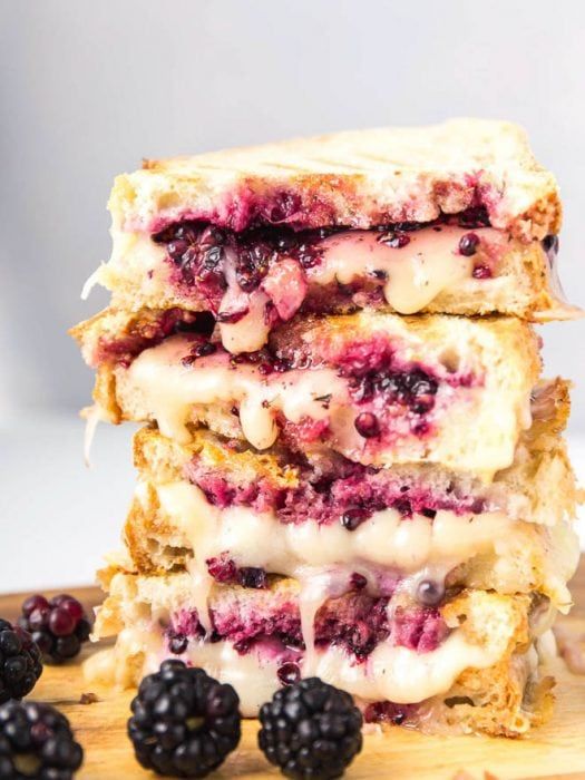 three pieces of toast stacked on top of each other with berries