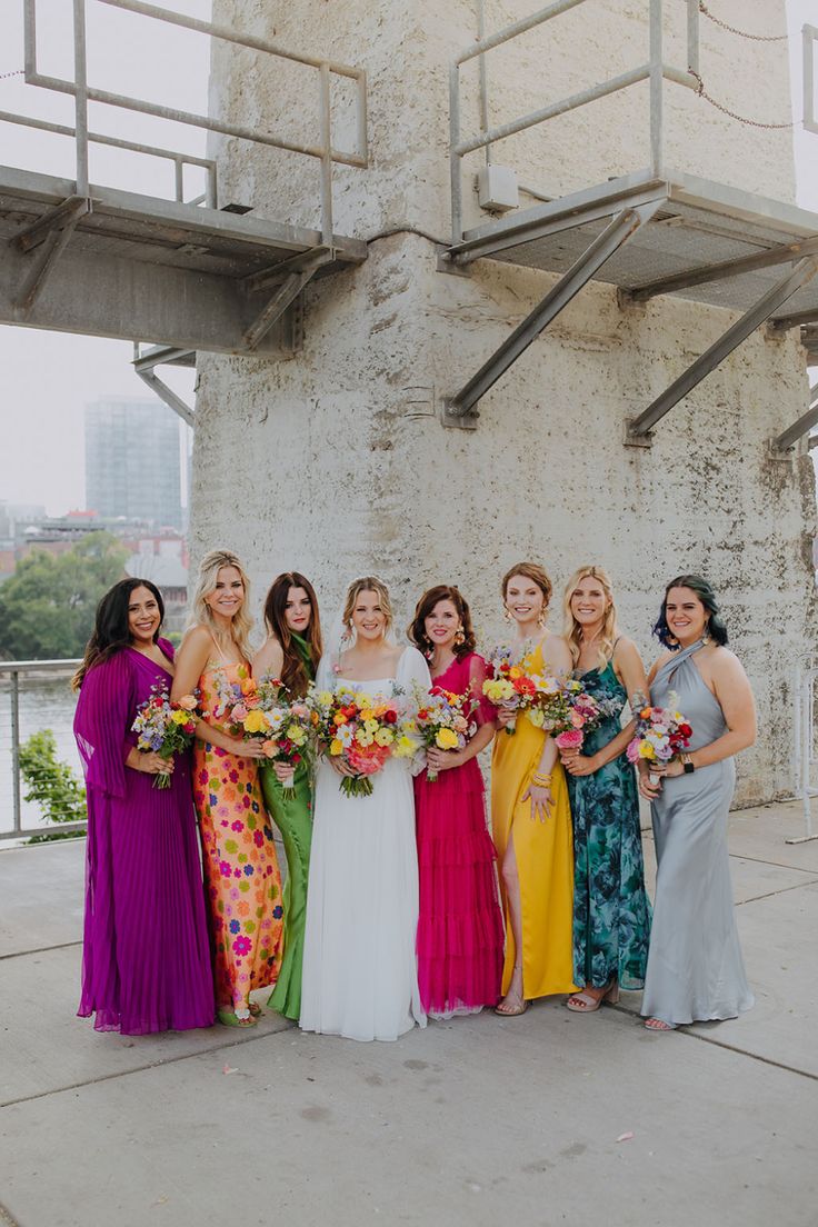 Unique Colorful Mismatched Bridesmaid Dresses for Spring Wedding with Vibrant Floral Bouquets Summer Boho Bridesmaid Dresses, Bright Jewel Tone Bridesmaid Dresses, Colourful Mismatched Bridesmaids, Mixed Color Bridesmaid Dresses Summer, Unique Bridesmaid Dresses Boho, Bold Colorful Wedding, Bright Summer Bridesmaid Dresses, Different Colour Bridesmaids, Bridesmaids With Different Color Dresses